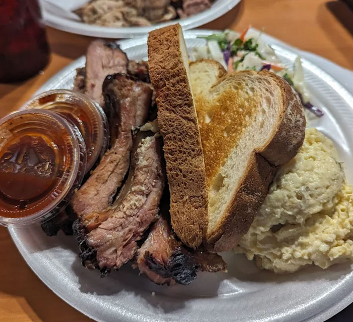 BBQ platter with brisket, ribs, sausage, and smoked chicken from Moma T’s BBQ near Canton, TX
