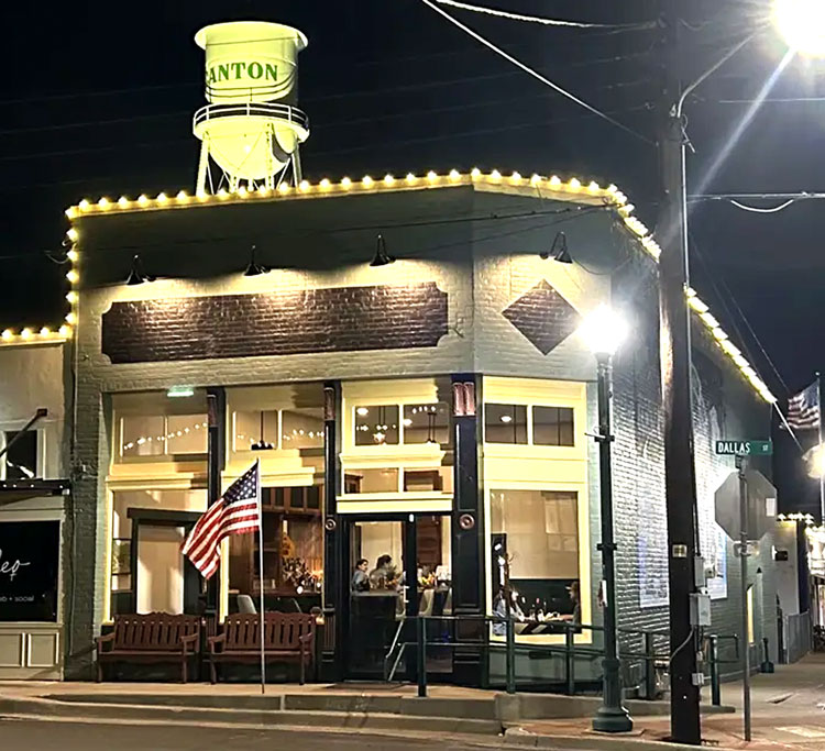 Exterior of Native Son Family Restaurant under the Canton water tower, serving homestyle comfort food in Canton, TX.